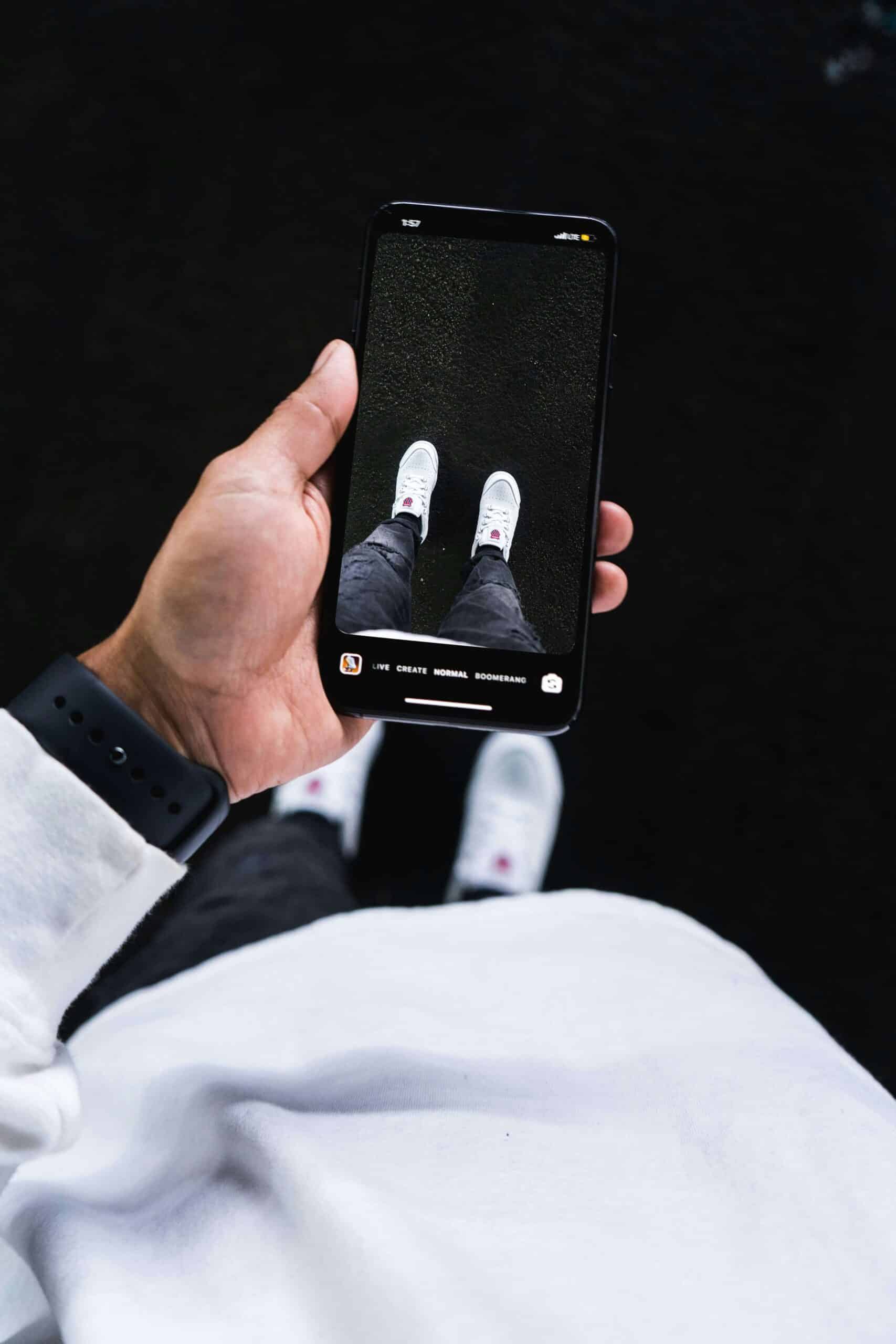 Person taking a picture of their shoes.